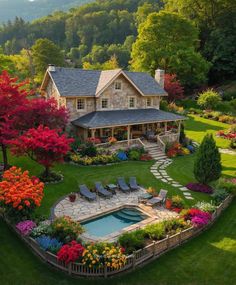 an aerial view of a house and pool surrounded by flowers