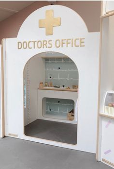 the doctor's office is decorated in white with gold lettering and an arched doorway