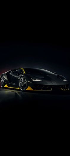 a black and yellow sports car in the dark