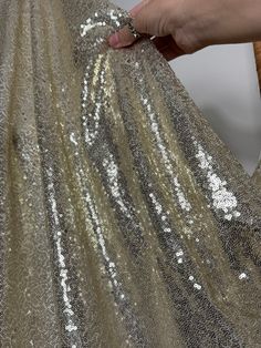 Introducing our exquisite 3mm Gold Sequins Glitz on Mesh Fabric - the epitome of glamour and sophistication! This stunning fabric is a perfect choice for creating show-stopping gowns, enchanting party dresses, and eye-catching event decorations. The dazzling gold sequins are meticulously arranged on a high-quality mesh base, creating a luxurious texture that catches the light with every movement. Not only does this fabric boast a radiant aesthetic, but its 2-way stretch ensures optimal comfort and flexibility, making it an ideal choice for garments that demand both style and ease of movement. Whether you're designing a red carpet-worthy gown, a memorable party dress, or crafting a backdrop for unforgettable photos and event decorations, our Gold Sequins Glitz on Mesh Fabric is the perfect Glamorous Floor-length Sparkling Sequin Fabric, Sparkling Champagne Sequin Fabric For Evening, Champagne Sparkling Sequin Fabric For Evening, Metallic Sequin Fabric For Evening Glamour, Sparkling Sequin Fabric For Prom And Holiday, Metallic Sequin Fabric For Evening, Glamorous Shimmer Sequin Fabric For Gala, Glamorous Metallic Sequin Fabric For Evening, Metallic Shimmer Sequin Dress For Holidays