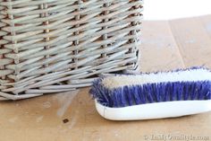 a blue and white brush sitting next to a wicker basket