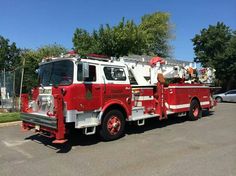 a red and white fire truck parked in a parking lot