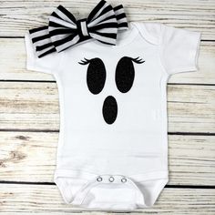 The perfect "easy" halloween costume or outfit. This bodysuit is made using black glitter HTV. Your choice of purchasing just the bodysuit, or the bodysuit and bow headband.  I use Laughing Giraffe bodysuits and they fit true to size with room to grow.  Short and long sleeve options available sizes 2T through 5T are t-shirts and not bodysuits Please message me with any questions! Halloween Party Black Bodysuit, Black Halloween Party Bodysuit, Fitted Cute Black Bodysuit, Cute Fitted Black Bodysuit, White Bodysuit For Halloween Costume Party, Playful Fitted Black Onesie, Black Fitted Playful Onesie, Cute Black Halloween Onesie, Playful Fitted Black Bodysuit