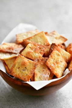 a bowl filled with crackers sitting on top of a table