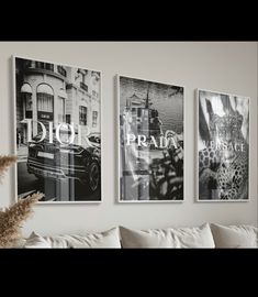 three black and white pictures hang on the wall above a couch in a living room