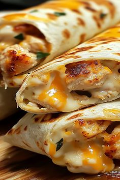 two quesadillas stacked on top of each other with cheese and chicken in them