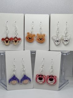 Celebrate the charm of your favorite character with these hand painted dangle earrings. The earring hooks  are made of .925 silver-plated they are  copper, and nickel-free and Hypo-allergenic. The earring backs are made of clear silicone, for comfort.  These characters are Tigger, Winnie, Piglet, Eeyore , and Strawberry Bear. Each is a hand painted acrylic design.  These character inspired earrings would make the perfect sweet gift for friends and family. They are versatile and ideal for any occasion, for everyday, and special events. They would be perfect for character enthusiasts, whether it's a birthday, holiday, or a thoughtful HAPPY to brighten they're day.  Every girl deserves earrings, as BEAUTIFUL as YOU are!! Count The Happies :) Playful Silver Earrings, Silver Playful Earrings, Handmade White Plastic Earrings, Themed Polymer Clay Jewelry For Gifts, Handmade Silver Fun Earrings, Fun Handmade Silver Earrings, Handmade Fun Silver Earrings, Novelty Multicolor Earrings With Ear Wire, Silver Fun Dangle Earrings