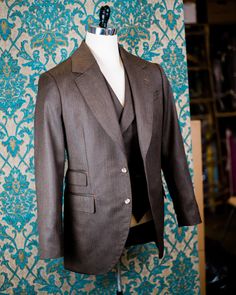 "ABOUT THIS STYLE: The style features a 1930s style jacket with a low gorge and a ticket pocket, a double-breasted notch collar vest, and a high-waisted pant with an extended waistband tab. With all of our designs, we look backward across the great history of menswear and try to bring forward is best and most fresh from the past, discarding what does not speak to our present age, but retaining all of the traditional craftsmanship and quaility. The suit is made from a vintage style herringbone su Fitted Double-breasted Three-piece Suit With Single Button, Classic Double Breasted Suit With Pockets, Timeless Fitted Double Breasted Suit With Lapel Collar, Fitted Double-breasted Tweed Jacket With Pockets, Tailored Three-piece Suit With Lapel Collar And Pockets, Classic Double-breasted Three-piece Suit With Single Button, Classic Semi-formal Double Breasted Suit With Pockets, Fitted Double Breasted Suit With Notch Lapel, Luxury Fitted Tweed Jacket With Welt Pockets