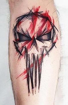 a man's leg with a red and black tattoo design on the side of his leg