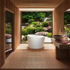 a large white bath tub sitting inside of a bathroom next to a stone counter top