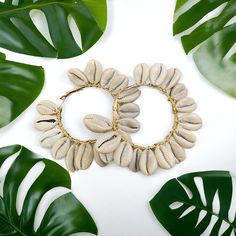 Gold hoops with cowrie shells. Handmade Cowrie Shell For Summer, Bohemian White Hoop Earrings For Beach, Handmade Cowrie Shell Decor For Summer, Cowrie Shell For Vacation And Summer, Cowrie Shell Earrings For Beach, Beach Cowrie Shell-shaped Earrings, Handmade Hoop Earrings For Summer Vacation, Handmade Cowrie Shell Earrings For Beach, Bohemian Shell Hoop Earrings For Beach