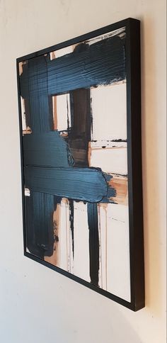 an abstract painting hangs on the wall