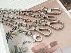 Broken/Missing strap on purse replaced? This versatile silver bag chain strap provides you with a chance to replace the strap or add a luxury chain strap to your purse in case of a missing or broken strap. This replacement handle chain can work great on a handbag, shoulder bag, tote, purse, wallet, cross-body bag, clutch, etc. The bag chain is made of polished stainless steel and has exquisite craftsmanship for an everlasting impression. This diamond-cut bag chain was designed with versatility in mind, with an attractive and polished design.   PRODUCT ● DETAILS ▶Material: Steel Chain, Stainless Steel Clasp, Alloy Clasp ▶Chain Color: Silver.  ▶Includes: 1 x High-quality Steel Strap W/Two Clasps ▶Total Length (end to end incl clasps) - 15cm to 140cm; Chain Length - 6cm to 135cm. Please allow Silver Bag, Chain Diamond, Silver Bags, Gold Bag, Bag Chain, Purse Strap, Handbag Straps, Best Bags, Engraved Items