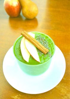 green smoothie with apple slices and cinnamon on top