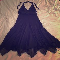 a purple dress laying on top of a bed