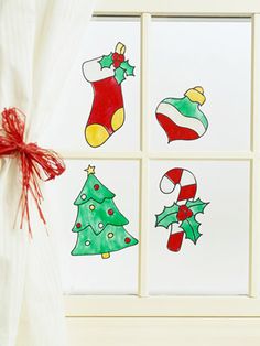 four christmas cards on a window sill with red bows and green stockings hanging from them