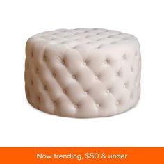 a white cake sitting on top of a table next to an orange sign that says $ 50 & under