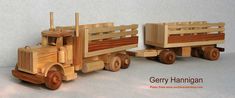 two wooden toy trucks sitting next to each other on a white surface with the words gery hamgan written below it