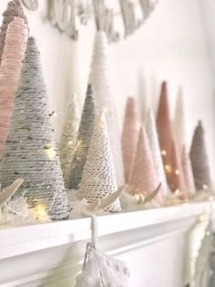 christmas trees are lined up on the mantle