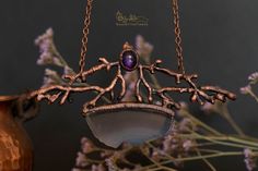 This is an one of a kind necklace inspired by nature. It features some fake tree branches embellished with an amethyst and a purple agate piece. Everything has been covered in copper and then varnished in order to protect the patina. This piece of jewelry would be perfect for a wicca or pagan person. The pendant measures approximately 11.5 cm (4.5 in) in width and 6 cm (2.4 in) in height. The necklace is adjustable between 40 cm (15.8 in) to 50 cm (19.7 in) in length. The colors of the product m Unique Hand Forged Purple Necklaces, Unique Purple Copper Necklace, Handmade Amethyst Necklace Nature-inspired, Bohemian Amethyst Soldered Necklace, Bohemian Amethyst Necklace, Fake Trees, Branch Necklace, Purple Agate, Tree Branches