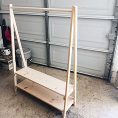 a wooden shelf sitting in front of a garage door