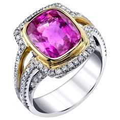 When searching for a top-quality pink sapphire, this is the color to aspire to! This large, vivid pink sapphire possesses an ideal, highly saturated, bright pink hue with beautiful brilliance and life. It is set in a rich, yellow gold bezel, surrounded by round brilliant cut diamonds set in white gold. The contrast of colors in this modern yet classic design is truly eye-catching. The pink sapphire is accompanied by Gemological Institute of America Report #1156860843. A gem pink sapphire in an e Ruby Necklace Designs, Pink Sapphire Diamond Ring, Pink Sapphire Jewelry, Sapphire Jewellery, Vintage Cocktail Ring, Pink Spinel, Sapphire And Diamond Ring, Gold Cocktail Ring, Stylish Rings