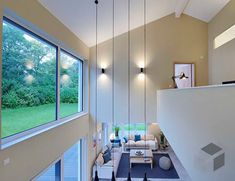 a living room filled with furniture and lots of windows