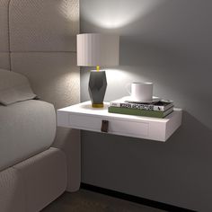 a nightstand with a lamp on it next to a bed