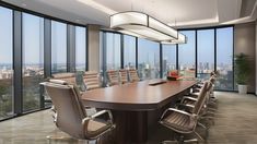 a large conference table in an office with panoramic windows looking out on the city