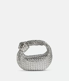 a silver ring with braiding on the outside and inside, against a white background