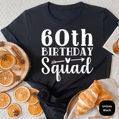 a t - shirt that says talk sixty to me surrounded by sliced oranges and croissants