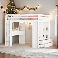 a white loft bed with desk underneath it and christmas decorations on the wall behind it