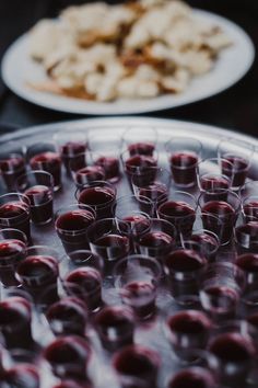 there are many glasses on the table ready to be filled with wine and desserts