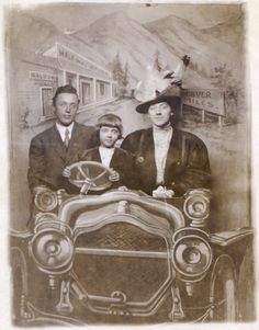 an old black and white photo of two men and a woman in front of a car