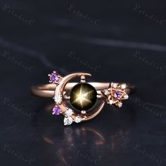 5mm Art Deco Round Black Star Sapphire Moon Halo Ring Rose Gold Dainty Amethyst Star Engagement Ring Vintage Birthstone Ring Promise Ring Women Side stones: amethyst and Moissanite This ring can also be made in genuine solid 10k, 14k, 18k gold or Platinum, and all the rings in my shop can be customized too! If you want to know more details about the ring, just contact with me anytime! If you want to customize the ring, just contact with me anytime! If you want to make a custom jewelry, just contact with me anytime! PROCESS TIME AND SHIPPING It usually takes about 3-4 weeks to finish the ring and 4-6 days to deliver to you if you are in US. (Free Shipping within US!) We will offer you the tracking number once your ring is shipped. WARRANTY 30 days money back guarantee! If you have any quest Magical Rose Gold Jewelry For Anniversary, Rose Gold Round Mystical Jewelry, Celestial Style Round Amethyst Jewelry, Mystical Rose Gold Round Jewelry, Black Celestial Engagement Ring, Celestial Round Amethyst Jewelry, Vintage Star Sapphire Ring, Black Star Sapphire Ring, Celestial Moon-shaped Ring With Rose Cut Diamonds