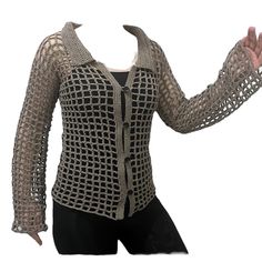 a mannequin wearing a black and white top with crochet on it