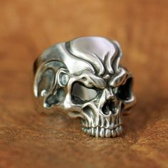 "It's a hard way to the top if you wanna rock and roll" ac/dc ! this silver skull ring will take you to the top, my friend! Are you a fan of rock? Like to listen or play to rock? Then these sterling silver rock rings is made for you. With this masterpiece on your finger, you can be sure that you will feel the power and the spirit of the greatest rockers ever through your veins. As you may have noticed, this skeleton head is well detailed with beautiful engravings all over the forehead, the sharp Punk Skull Ring For Streetwear, Punk Skull Ring For Halloween, Punk Style Skull Ring For Halloween Collectible, Punk Skull Ring For Halloween Streetwear, Silver Punk Skull Ring For Halloween, Silver Skull Ring For Halloween Streetwear, Silver Edgy Skull Ring For Halloween, Edgy Silver Skull Ring For Halloween, Silver Skull Ring For Halloween