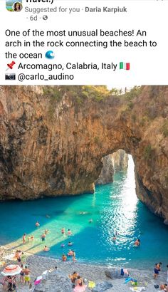 people are swimming in the blue water near a cave