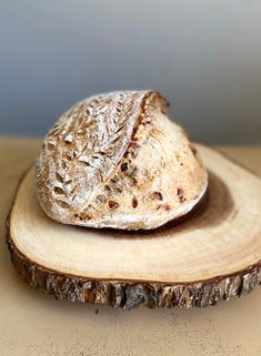 a loaf of bread sitting on top of a wooden slice