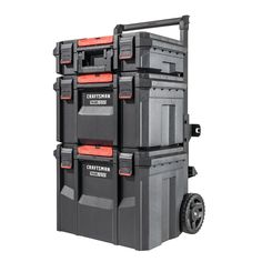 three large storage boxes stacked on top of each other with wheels and red trimmings