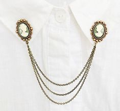 These collar pins are absolutely beautiful and unique and can turn a normal collared shirt into a fashion statement. They can also be worn on sweaters or dresses as shown in the second photo. These particular pins are made of antique brass settings with 14X10 mm light green cameos set in them. they are both connected by 3 antique brass chains which measure 12, 14, and 16cm. Also available in silver: https://www.etsy.com/listing/503504080/silver-cameo-collar-pins-collar-chain?ref=shop_home_active Collar Brooch, Sweater Clips, Collar Tips, Sweater Pin, Bee Pin, Sweater Clip, Marinette And Adrien