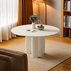 a living room with a couch, table and bookcases in it's corner