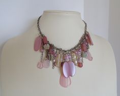 Girlish and playful, a tender, romantic, pastel colored short necklace from the '80s. Plenty of synthetic but of very good quality beads, in various shepes, beaded on a thich, silver tone chain. An authentic vintage piece of jewelry that could be worn at a party, a walk, even a wedding reception. In perfect condition. Please note that this is not a new item, so it is expected to have time signs on it. This is exactly what makes it unique. Pink Vintage Beaded Necklaces With Colorful Beads, Feminine Beaded Necklaces For Jewelry Making, Whimsical Pink Beaded Necklaces For Party, Pink Dangle Beaded Chain Necklaces, Pink Beaded Chain Necklaces With Dangle, Pink Dangle Necklace With Beaded Chain, Whimsical Pink Beaded Necklace For Party, Vintage Pink Choker Necklace, Vintage Pink Beaded Necklace As A Gift