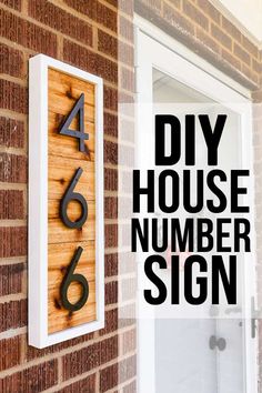 a wooden house number sign mounted to the side of a brick building next to a door