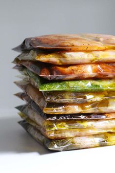 a stack of bags filled with food sitting on top of each other