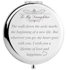 a round compact mirror with the words to my daughter on it