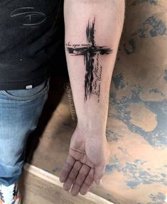 a person with a cross tattoo on their arm