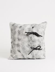 a black and white pillow with a tie on it