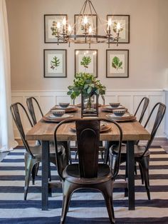 a dining room table with chairs and pictures on the wall above it that says home decor