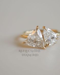 two pear shaped diamond engagement rings in yellow gold